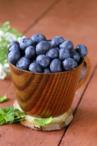 Fresh organic ripe blueberries in a wooden bowl — Stock Photo, Image