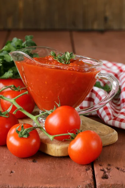 Traditional tomato sauce in a glass gravy boat — Stock Photo, Image