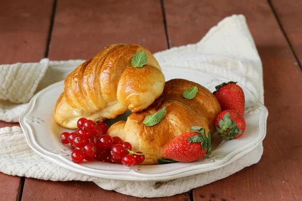 Frisches Croissant mit Beeren zum Frühstück auf Vintageteller — Stockfoto