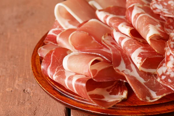 Sliced dried sausage meat (ham, prosciutto, salami) — Stock Photo, Image