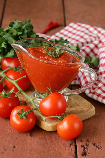 Traditional tomato sauce in a glass gravy boat — Stock Photo, Image