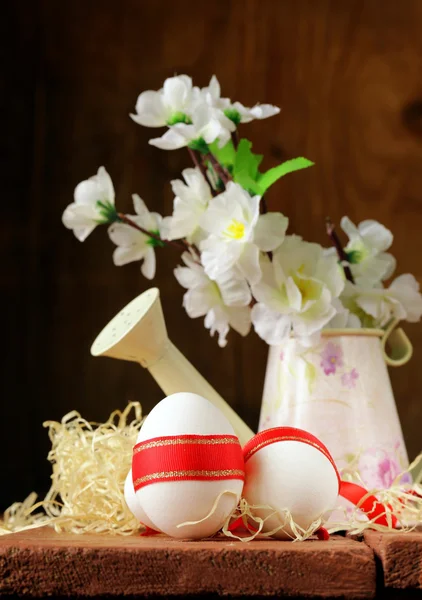 Festive eggs decorated with red ribbon - symbol of Easter holiday — Stock Photo, Image