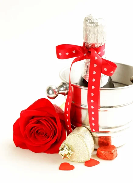 Romantic still life champagne, roses, gifts, chocolate Stock Picture