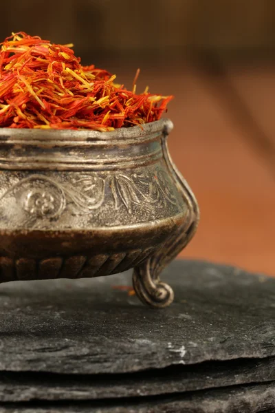 Saffron spice in metal bowl macro shot soft focus — Stock Photo, Image