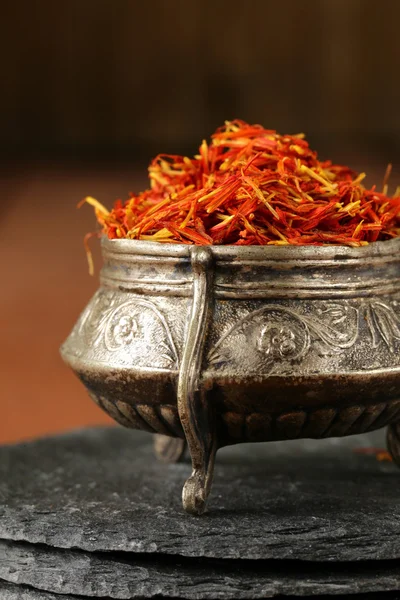 Saffron spice in metal bowl macro shot soft focus — Stock Photo, Image