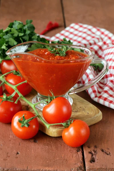 Traditional tomato sauce in a glass gravy boat — Stock Photo, Image