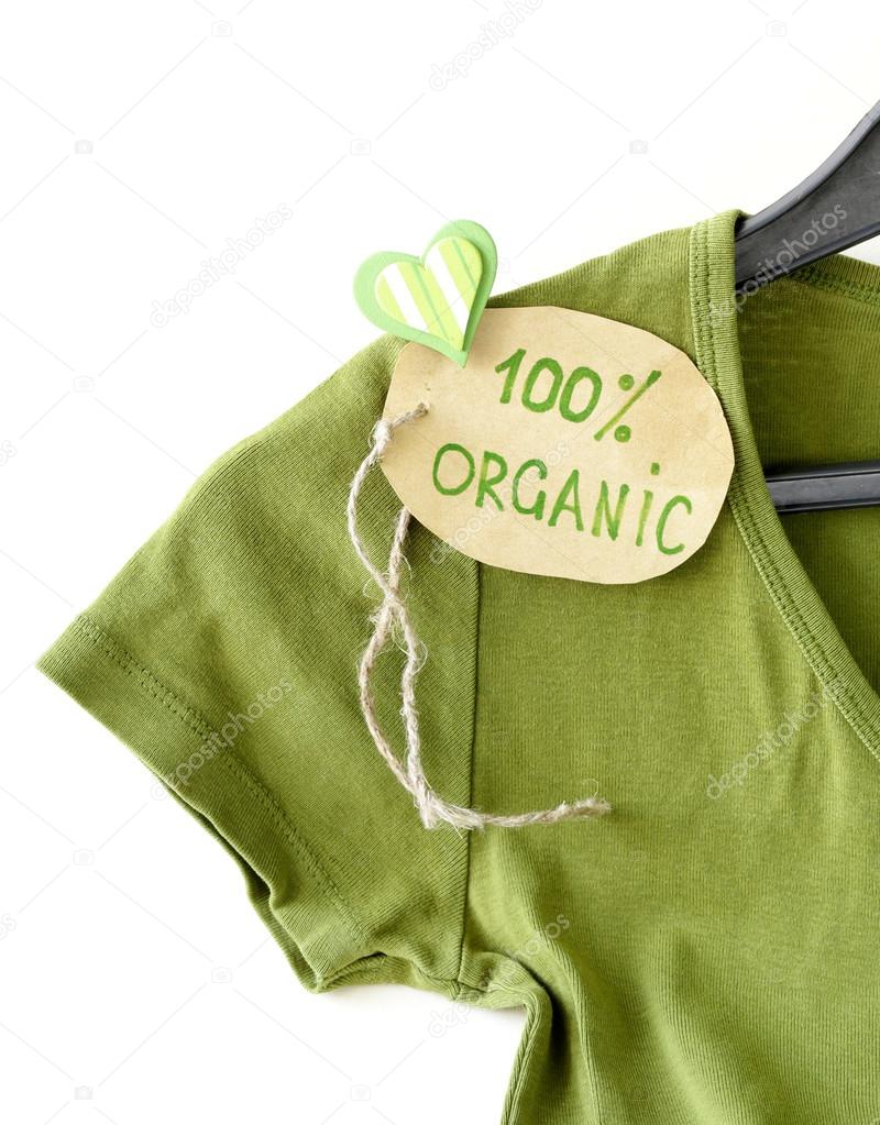 Green shirt with organic label on a hanger