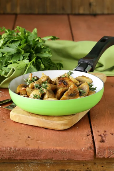 Fried champignon mushrooms with thyme in a pan — Stock Photo, Image