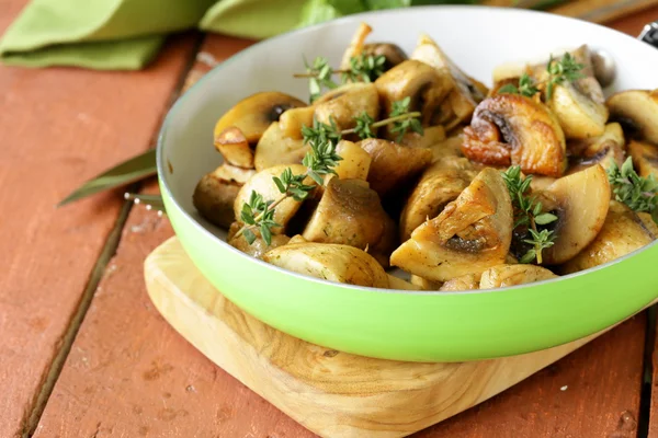 Fried champignon mushrooms with thyme in a pan — Stock Photo, Image