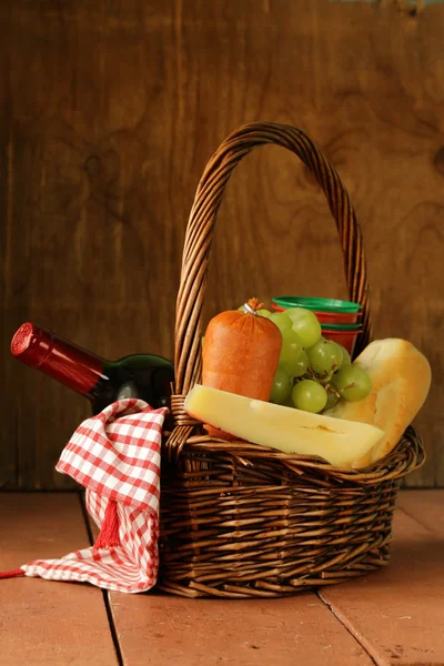 Picnic basket - wine, fruit, cheese and sausage — Stock Photo, Image