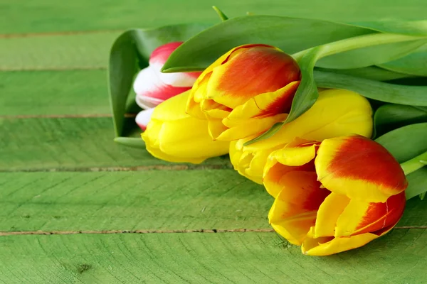 Spring tulips flowers on a wooden background — Stock Photo, Image