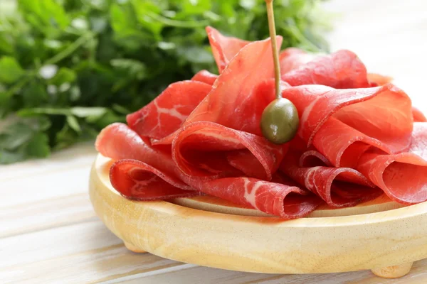Smoked meat bresaola snack on a cutting board — Stock Photo, Image