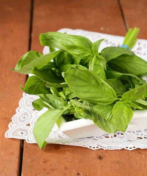 Organic fresh green basil on a wooden table — Stock Photo, Image
