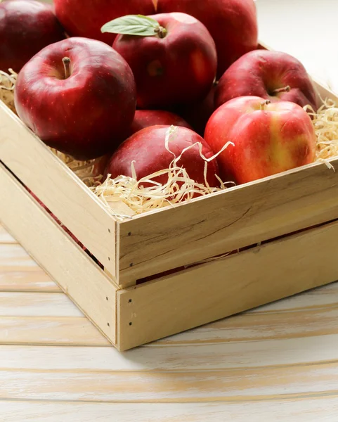 Fresh ripe organic red apples in a wooden box — Stock Photo, Image