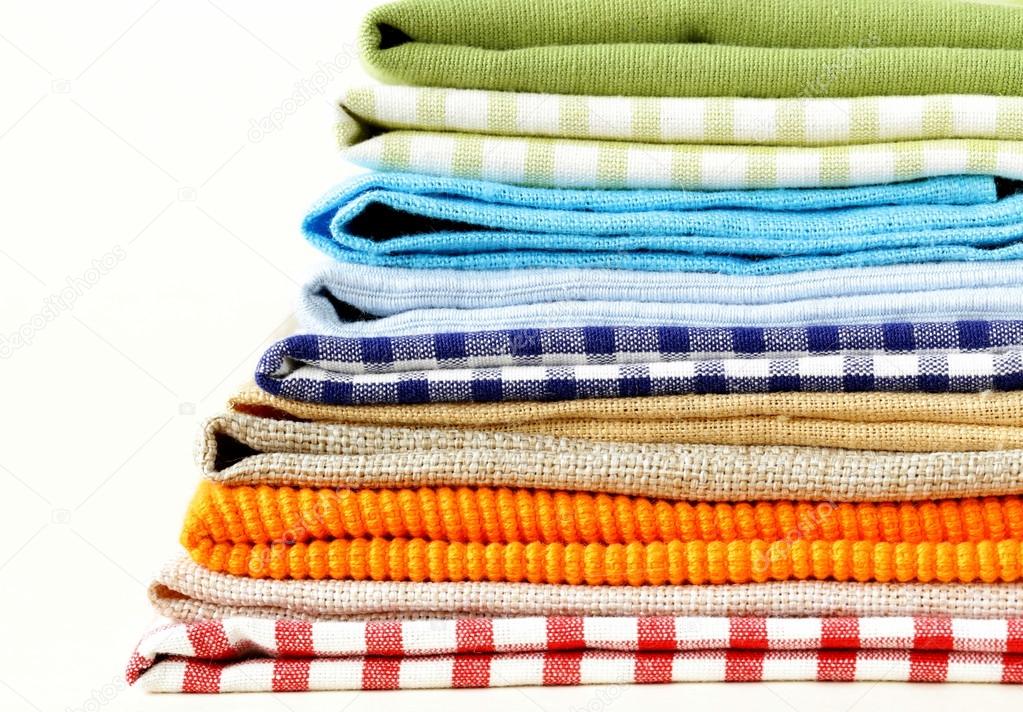 Stack of colorful kitchen napkins on white background