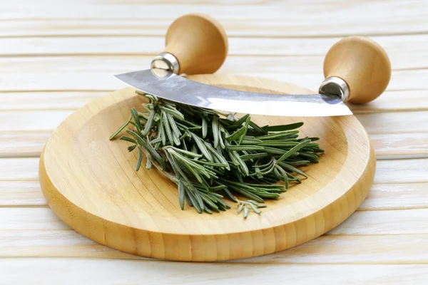 Fresh fragrant green rosemary on a cutting board — Stock Photo, Image