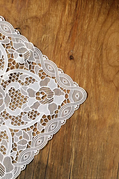 Old wooden background with white lace napkin — Stock Photo, Image