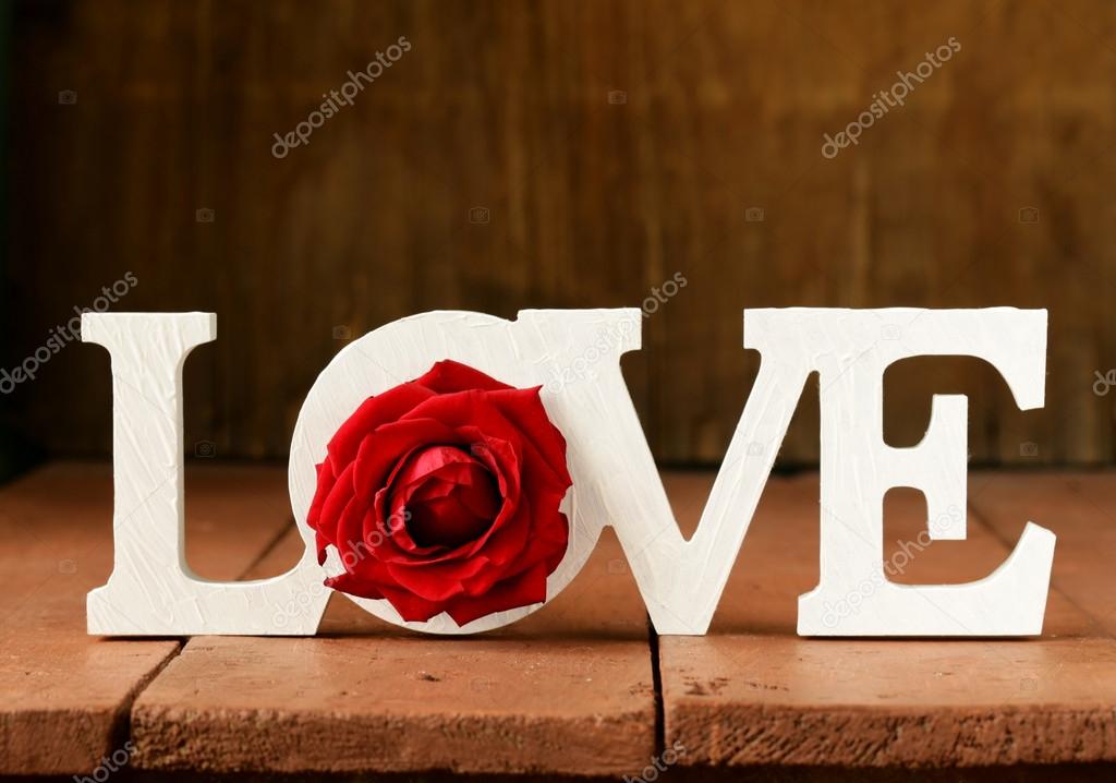 Word love made of white wooden letters on wooden background