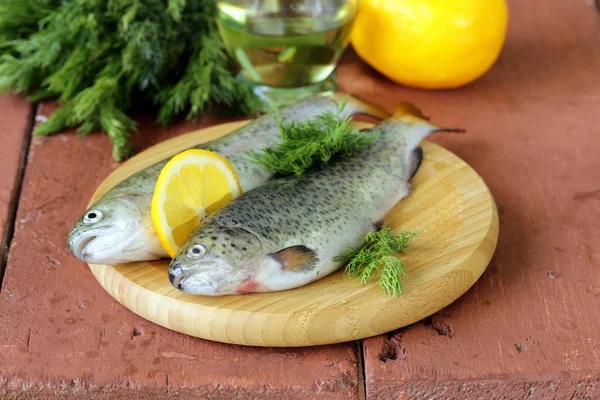 Fresh raw trout fish on the kitchen board — Stock Photo, Image