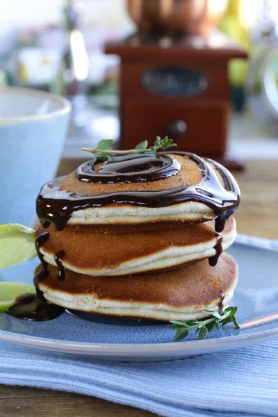 Homemade pancakes with chocolate syrup and thyme — Stock Photo, Image