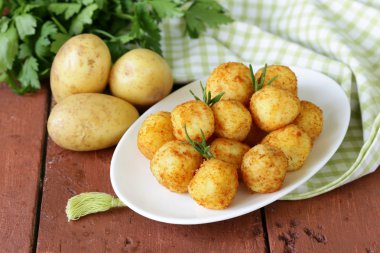 Fried potato balls (croquettes) with rosemary clipart