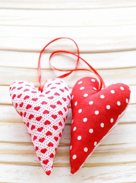Colorful handmade fabric hearts on a wooden background — Stock Photo, Image