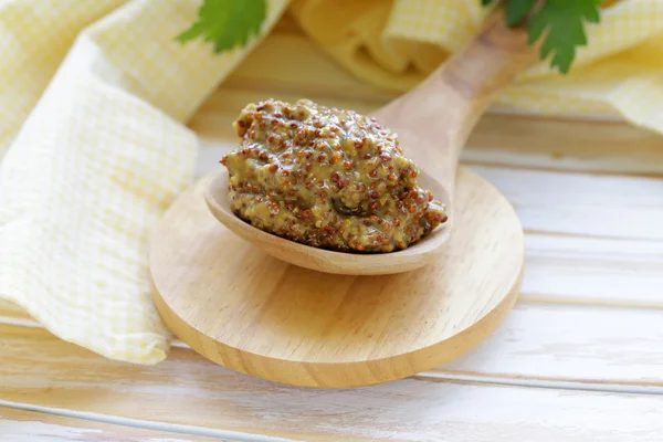 Traditional dijon mustard in a wooden spoon — Stock Photo, Image