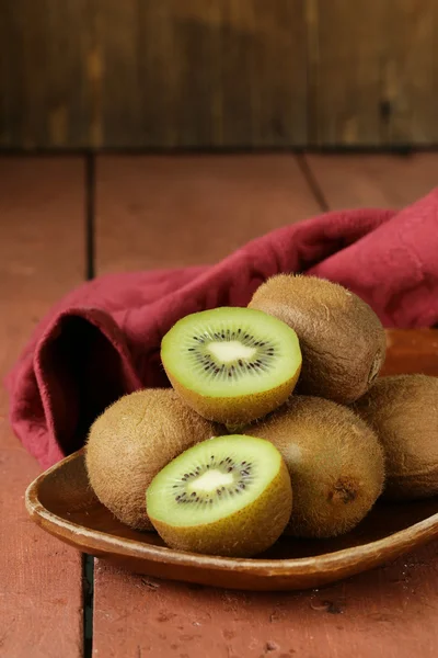 Tropical fruit fresh sweet ripe kiwi on wooden plate — Stock Photo, Image