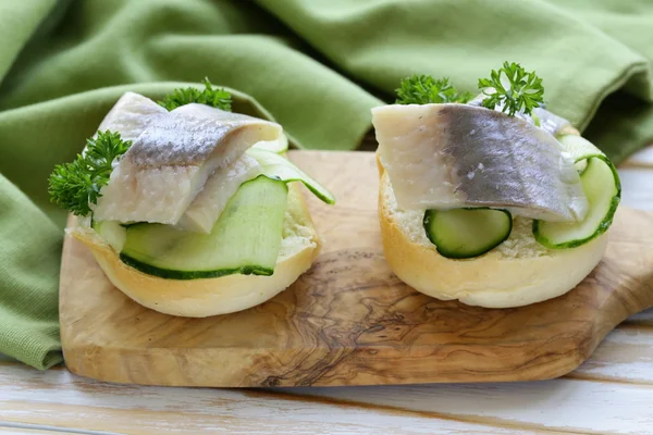 Snack sandwiches with cucumber and herring — Stock Photo, Image