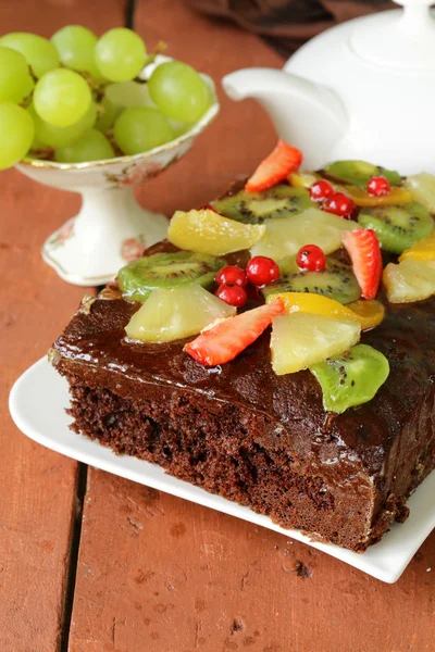 Chocolate brownie cake decorated with different fruits — Stock Photo, Image