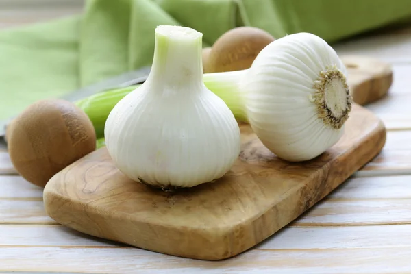 Fresh organic garlic on a wooden kitchen board — Stock Photo, Image
