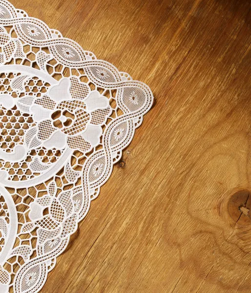Old wooden background with white lace napkin — Stock Photo, Image