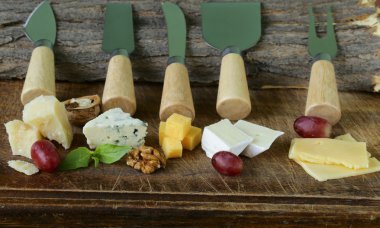 Cheeseboard with assorted cheeses (parmesan, brie, blue, cheddar) clipart