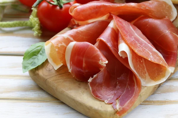 Parma ham (jamon) sliced on a wooden board — Stock Photo, Image
