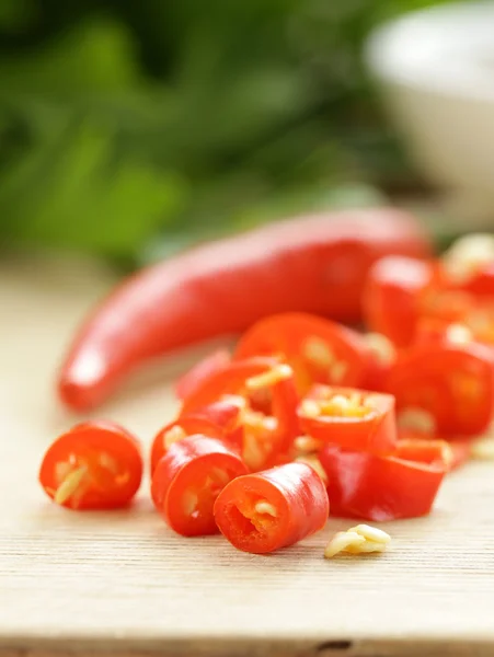 Fresh red chili peppers on a wooden board — Stock Photo, Image