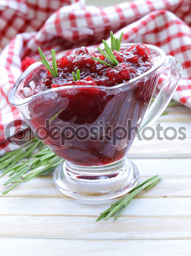 Traditional cranberry sauce with rosemary in a gravy boat