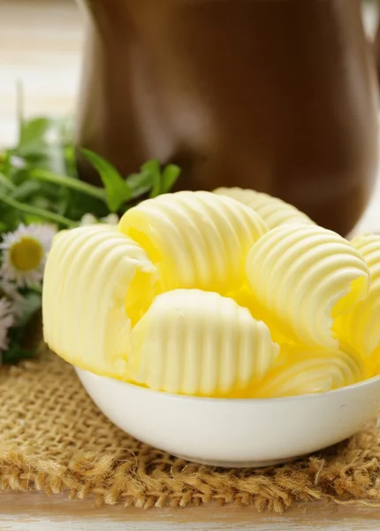 Fresh yellow dairy butter in a white bowl — Stock Photo, Image