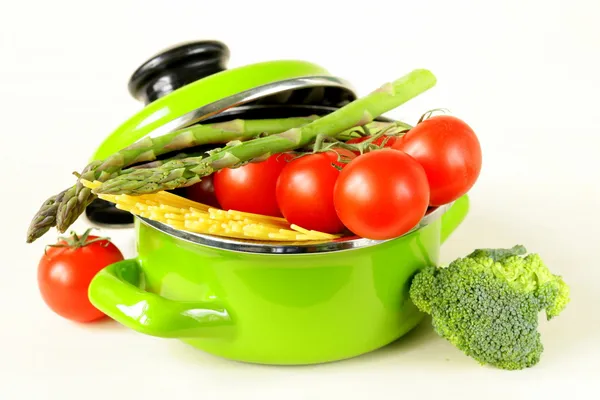 Panelas verdes cheias de vegetais (tomates, espargos, cogumelos, brócolis) e massas — Fotografia de Stock