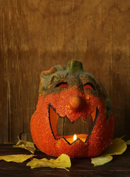 Halloween still life - pumpkin with  yellow leaves on the wooden background — Stock Photo, Image