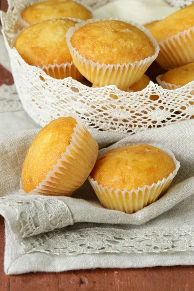 Homemade vanilla muffins in a basket of lace napkins — Stock Photo, Image