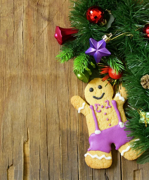 Traditional Christmas gingerbread man with festive decorations and Christmas tree — Stock Photo, Image