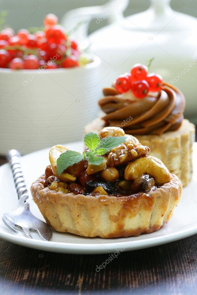 Small dessert pastries with nuts and berries for tea time