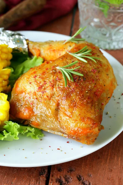 Baked chicken leg with corn for garnish — Stock Photo, Image