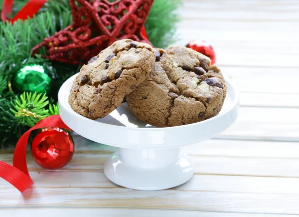 Biscuits au chocolat sur un fond en bois avec branches et décorations d'arbres de Noël — Photo