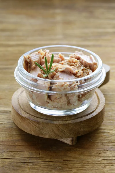 Canned tuna with rosemary in a glass jar — Stock Photo, Image