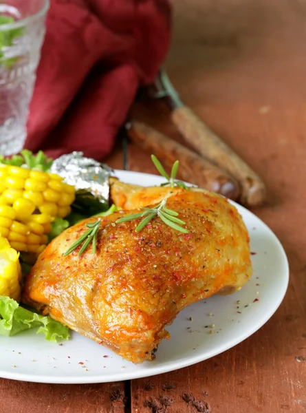Baked chicken leg with corn for garnish — Stock Photo, Image