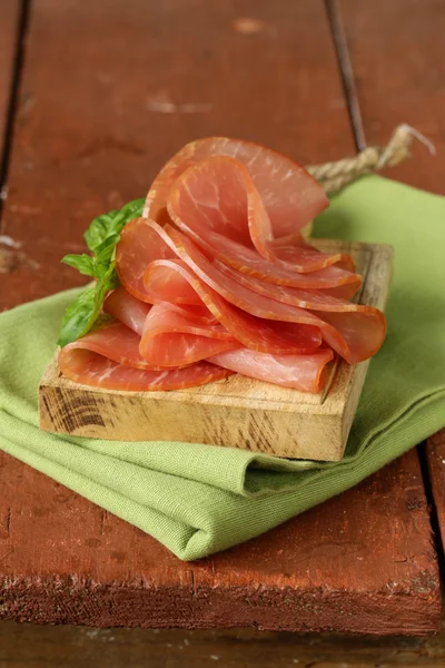 Prosciutto di maiale affumicato sul tagliere di legno — Foto Stock