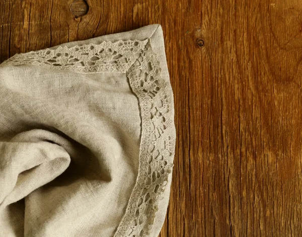 旧的木制背景，用灰色亚麻花边餐巾 — 图库照片