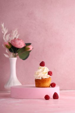 cupcake with cream and fresh berries
