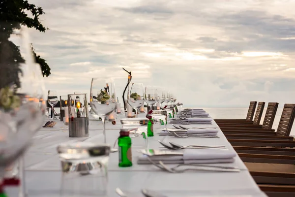 Long table wedding dinner setup on the beach at  Thailand